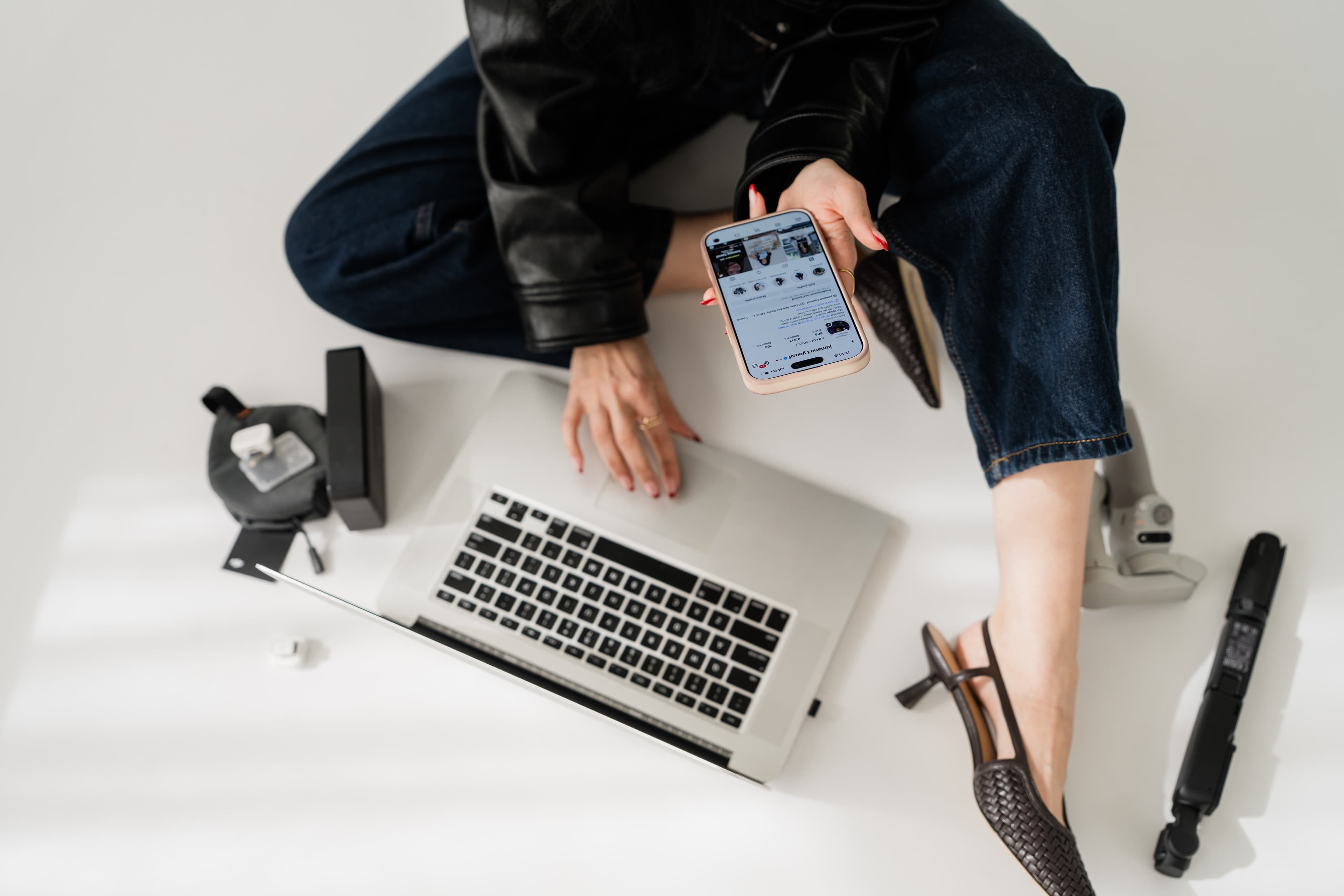 Overhead content strategy scene with laptop, phone, and creator tools