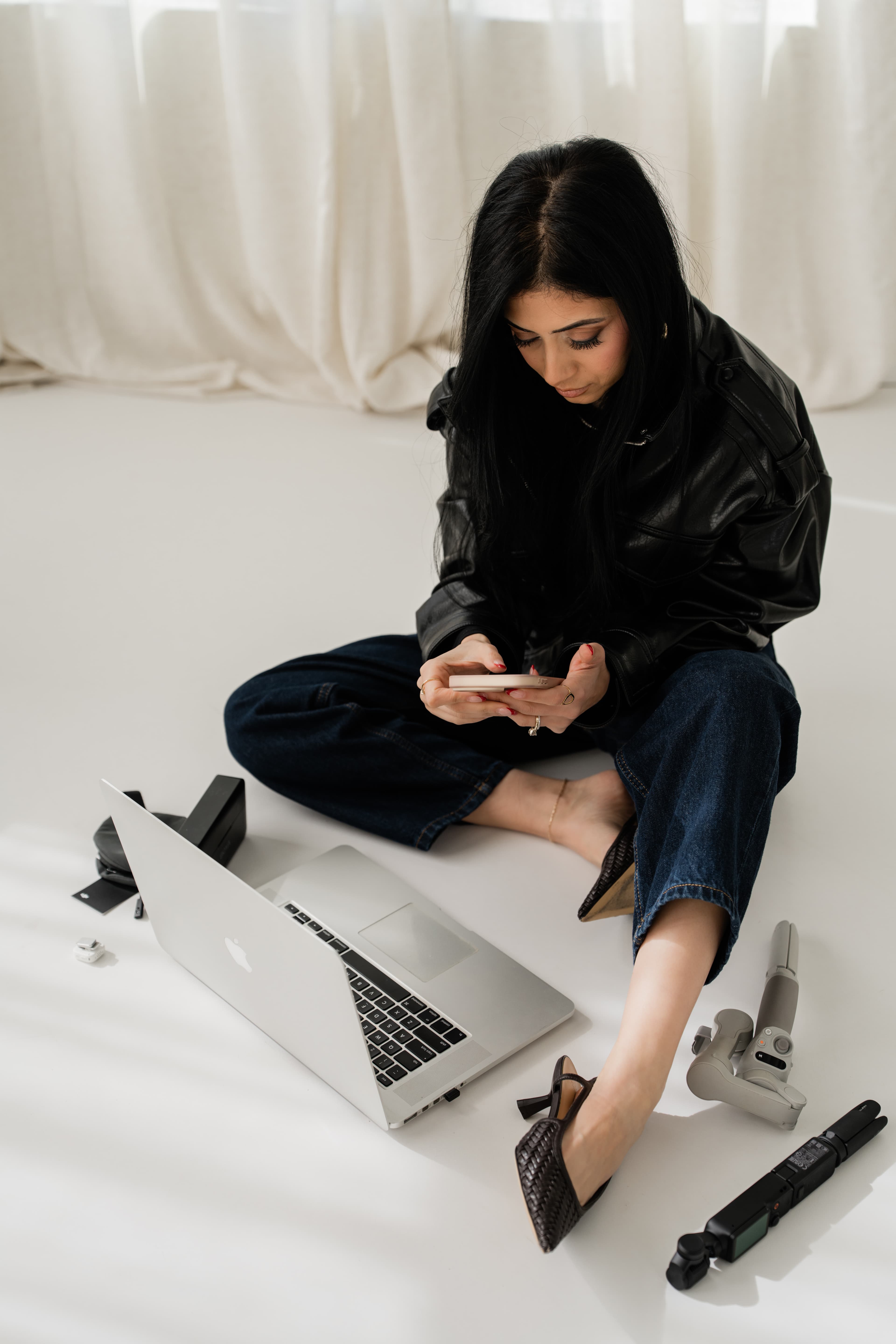 Jumana planning content from a laptop and phone